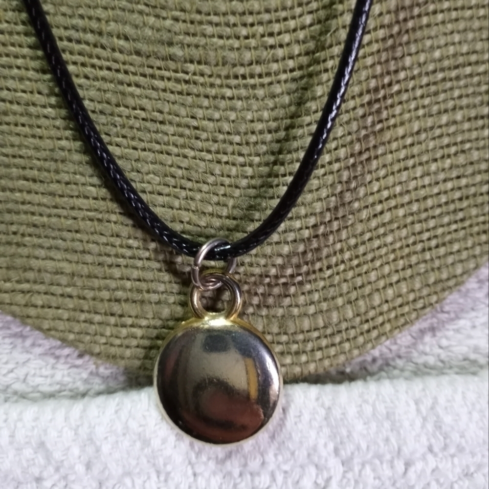 Goldtone solid round disk pendant on black cord necklace